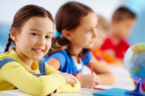 Little girl in classroom with other children